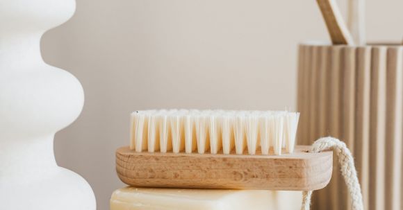 Sustainable Decor - Sustainable consumption concept collection of organic cruelty free soaps with wooden body brush near bamboo sustainable toothbrushes and ceramic white vase on marble tabletop in minimalist bathroom