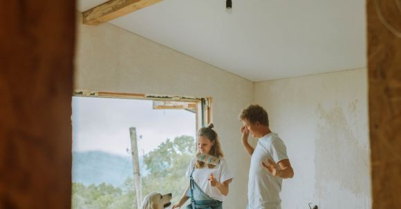 Renovation Tips - A Happy Couple Dancing With Their Dog