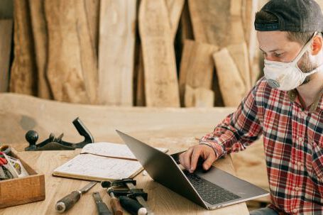 DIY Projects - Man Using a Laptop at a Wood Workshop