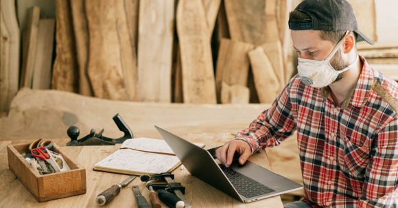 DIY Projects - Man Using a Laptop at a Wood Workshop