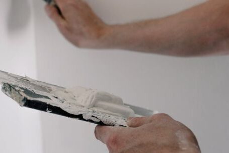 DIY Projects - Crop man working with putty at home