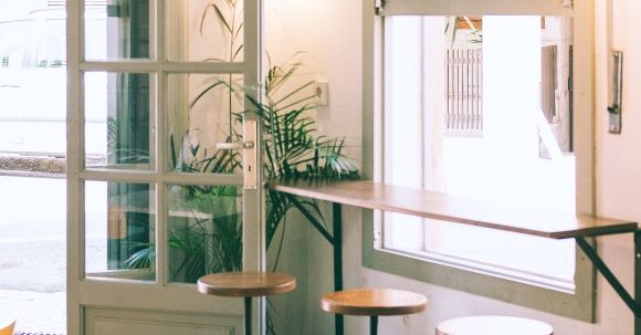Furniture - Interior of stylish cafe with wooden counter and stools placed near window