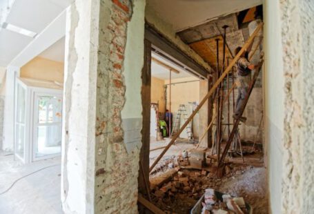 Renovation Tips - man climbing on ladder inside room