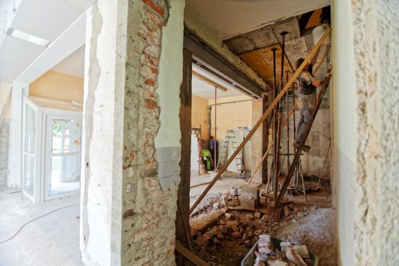 Renovation Tips - man climbing on ladder inside room