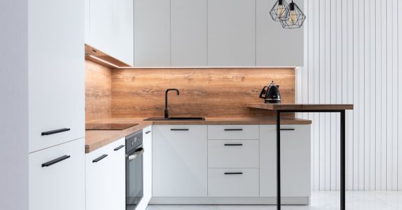 Kitchen Renovation - Contemporary interior of modern kitchen with comfortable white furniture and geometrical lamps hanging on ceiling