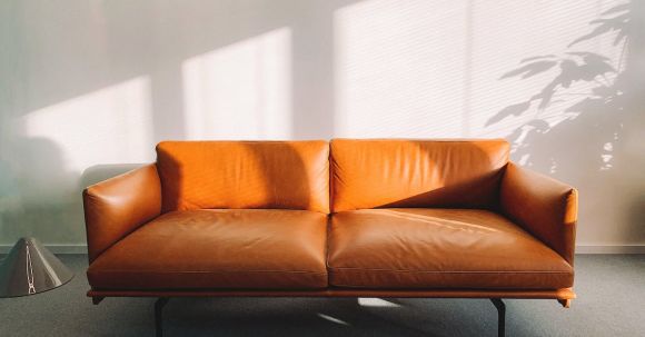 Furniture - 2-seat Orange Leather Sofa Beside Wall