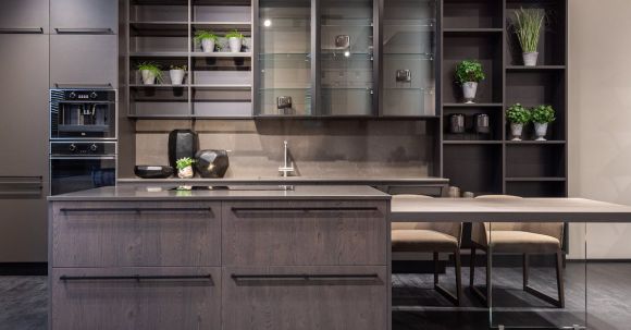 Kitchen Renovation - Contemporary kitchen interior design with empty dark furniture and decorative vases and plants