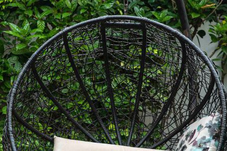 Backyard Landscape - Black Metal Framed Round Basket With Brown and White Throw Pillows