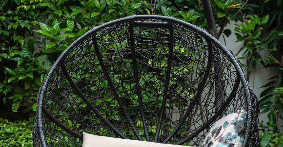 Backyard Landscape - Black Metal Framed Round Basket With Brown and White Throw Pillows
