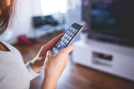 Smart Home - Woman Wearing White V Neck Shirt Using Space Gray Iphone 6