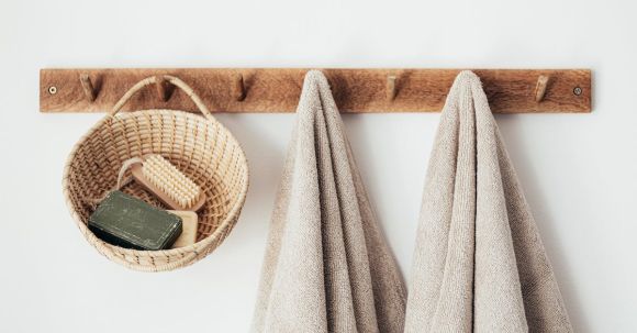 Sustainable Decor - Wooden hanger with towels and basket with bathroom products